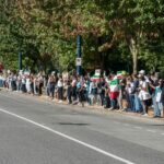 BREAKING: Britain Decides ‘Why Be Fast When You Can Be the Slowest?’—Unveils Europe’s LONGEST Immigration Queue 2 a large group of people marching on the street