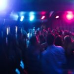 5 Reasons Suno and Warner Music Group Mark a Promising New Chapter in Interactive Music 2 Vibrant nightclub scene with blurred dancing crowd and colorful lights.