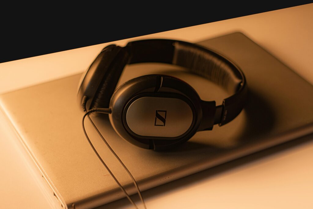 Sennheiser HDB 630 Review: A Wireless Headphone in a Completely Different League 3 Stylish Sennheiser headphones placed on a laptop, captured with warm lighting for a moody tech vibe.