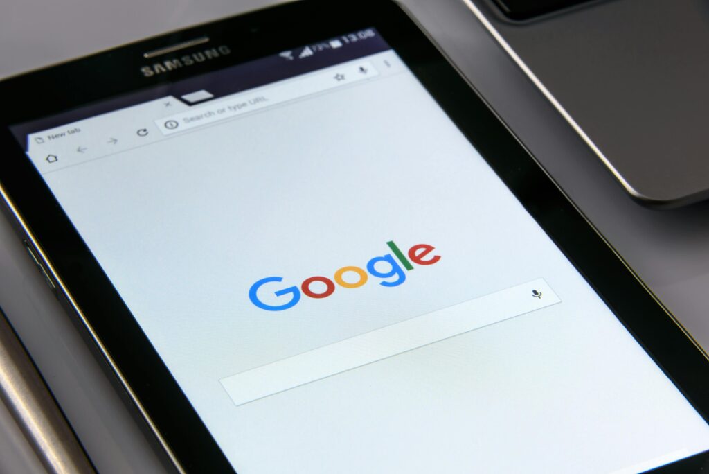 Sora and Nano Banana Pro Face Throttling as Demand Surges 6 Close-up of a tablet displaying Google's search screen, emphasizing technology and internet browsing.