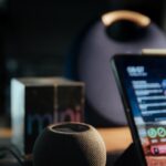 black iphone 5 on black and silver speaker